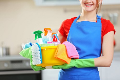 Cleaner tidying a modern SW15 apartment interior