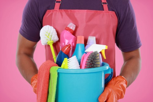 Carpet cleaning technician preparing equipment safely in SW15