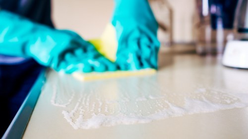Professional cleaner working in a SW15 residential property